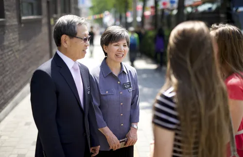 senior missionary couple with young women
