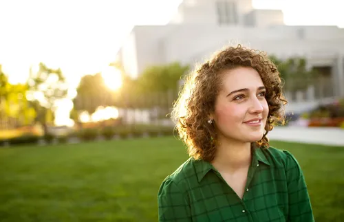 a woman standing in front of the temple and smiling