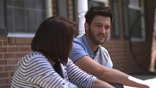 man and woman sitting on porch