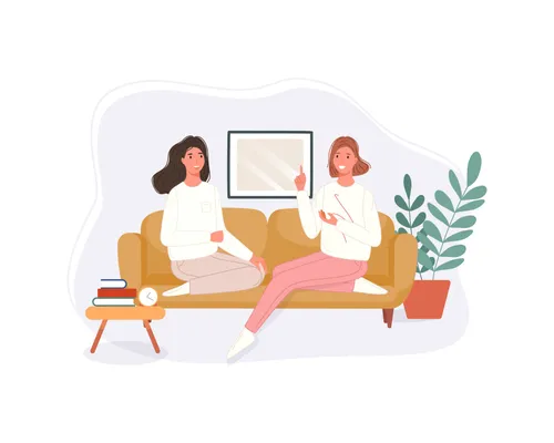 two women sitting and talking