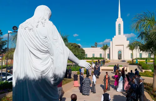 a Christus statue and some temple attendees in front of the Nairobi temple