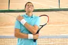 tennis player in pain holding his sholder
