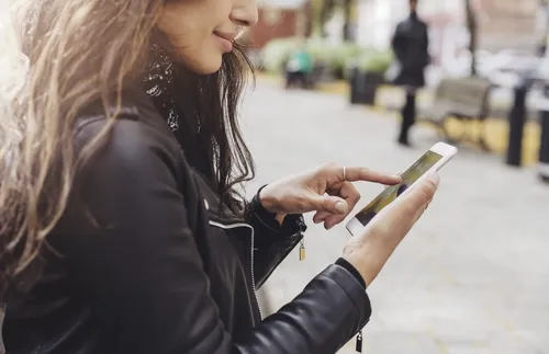 woman touching the screen of a smartphone