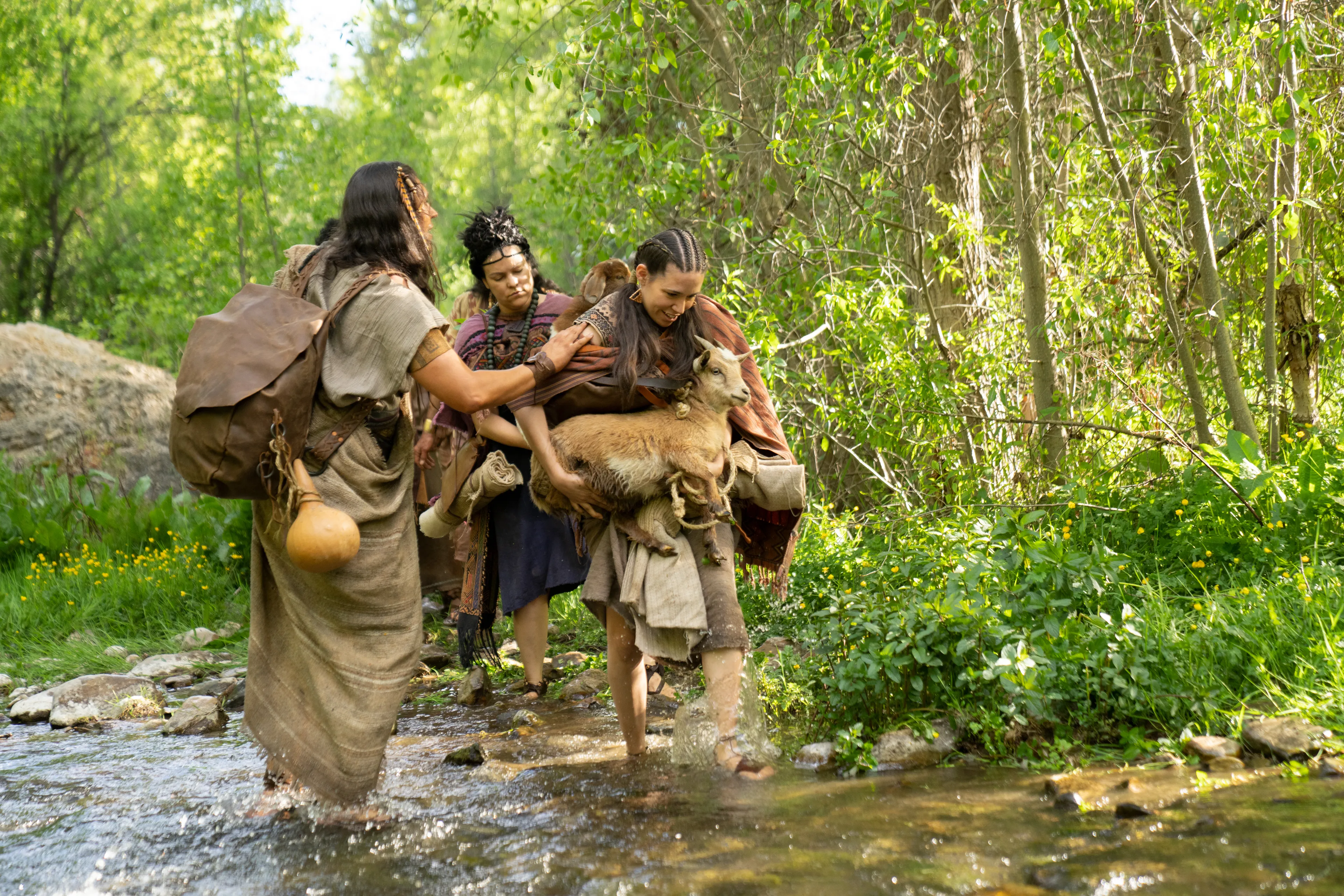 Ammon helps the people of Anti-Nephi-Lehi cross a river in the wilderness on their way to Zarahemla.