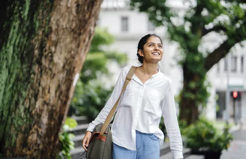 woman walking by tree