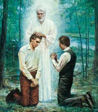 Joseph Smith, Jr. and Oliver Cowdery kneeling before John the Baptist. John the Baptist has his hands placed on the head of Joseph Smith, Jr. as he restores the Aaronic Priesthood. John is depicted wearing white. There are trees and a river in the background.