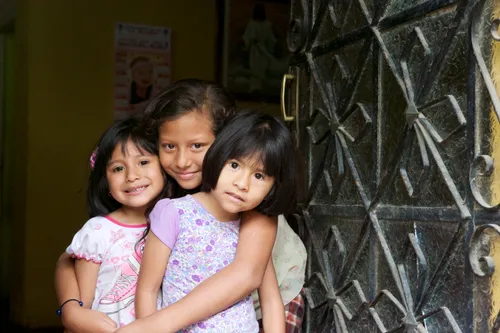 Young children in front of house in Peru