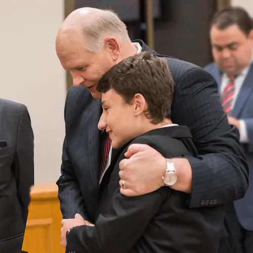 Dale G. Renlund with young man
