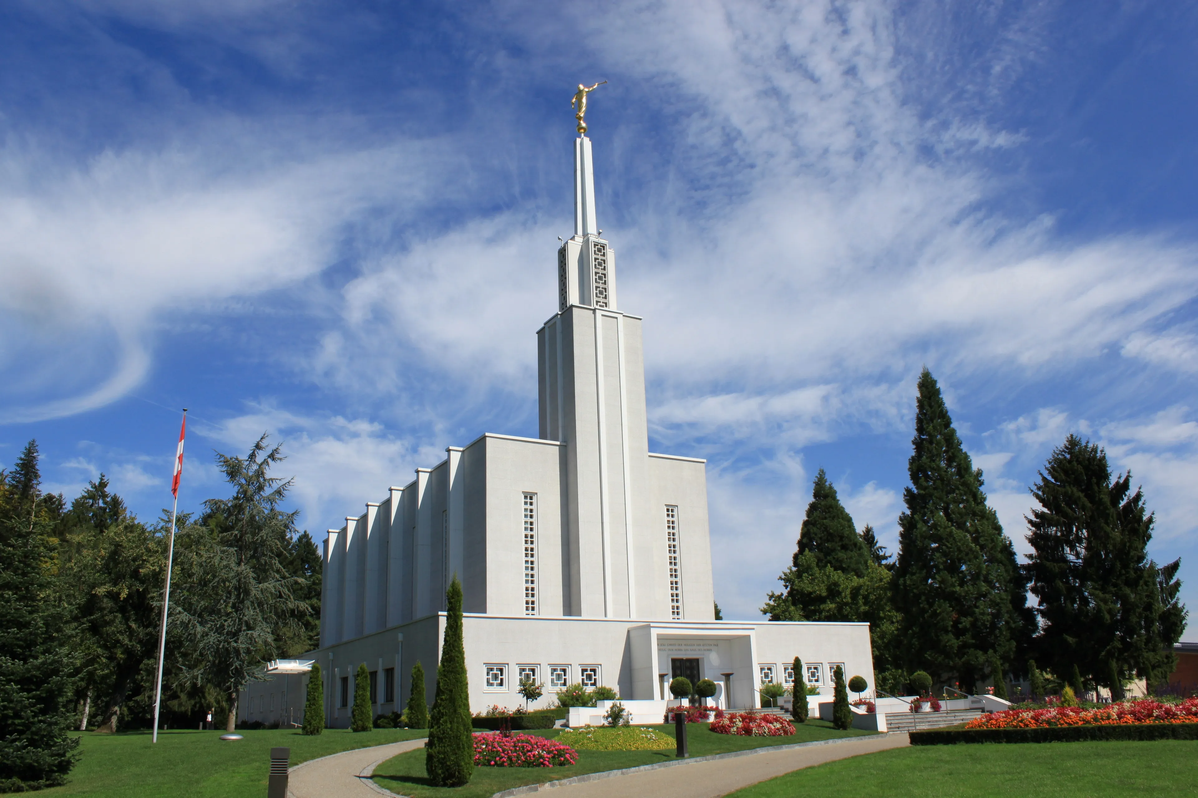 A landscape view of the Bern Switzerland Temple and grounds during the day.