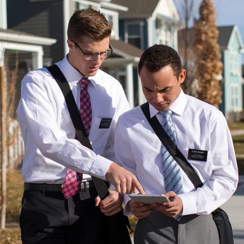 two missionary elders looking at a tablet