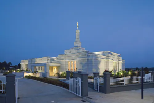 The Aba Nigeria Temple lit up, with the twilight sky in the background.
