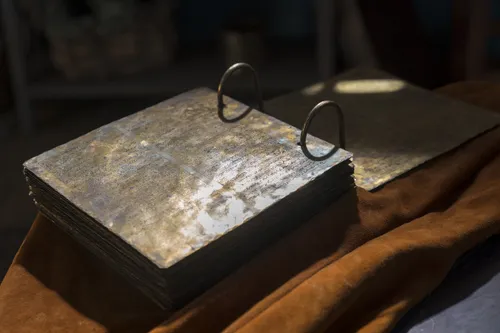 The brass plates sit open on a table.