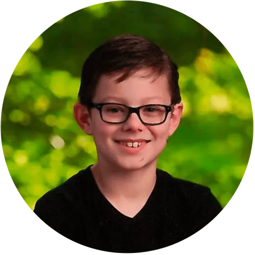 Paul Lyman a close up of his face with glasses and a tree in the background.