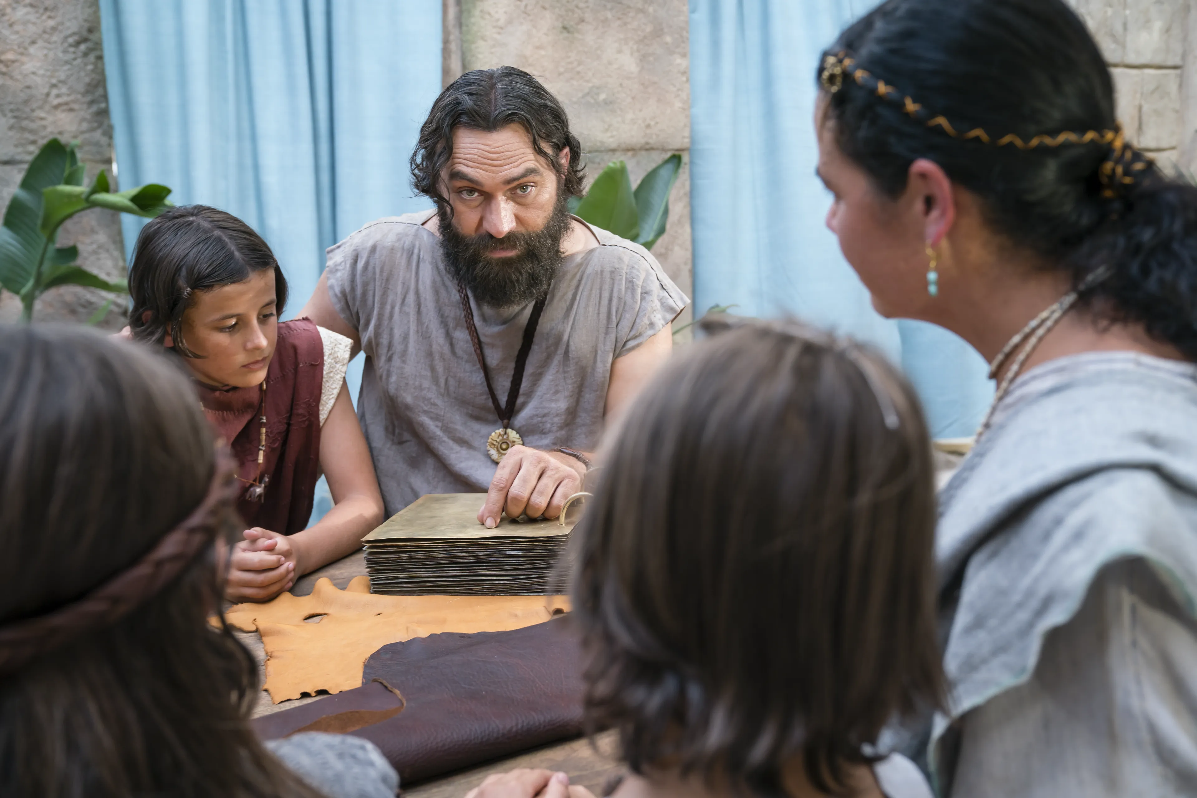 King Benjamin gathers with his family around a table in the Land of Zarahemla and tells them he can no longer be king.