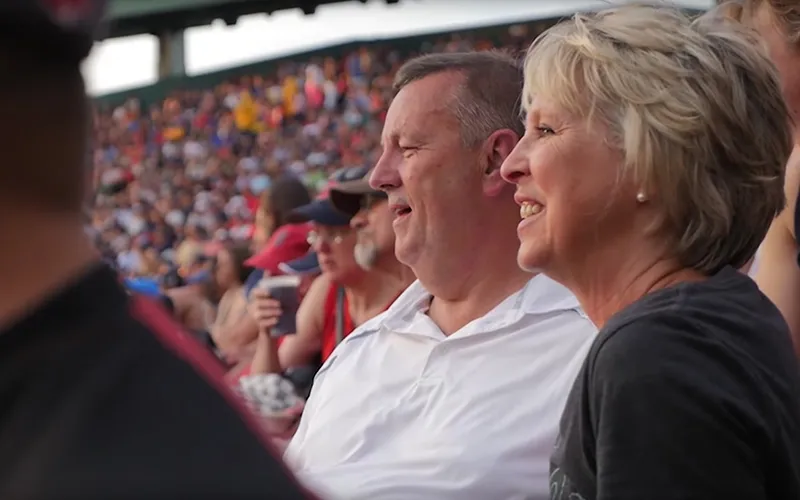 An older couple at a baseball game, explains the importance of marriage in the temple