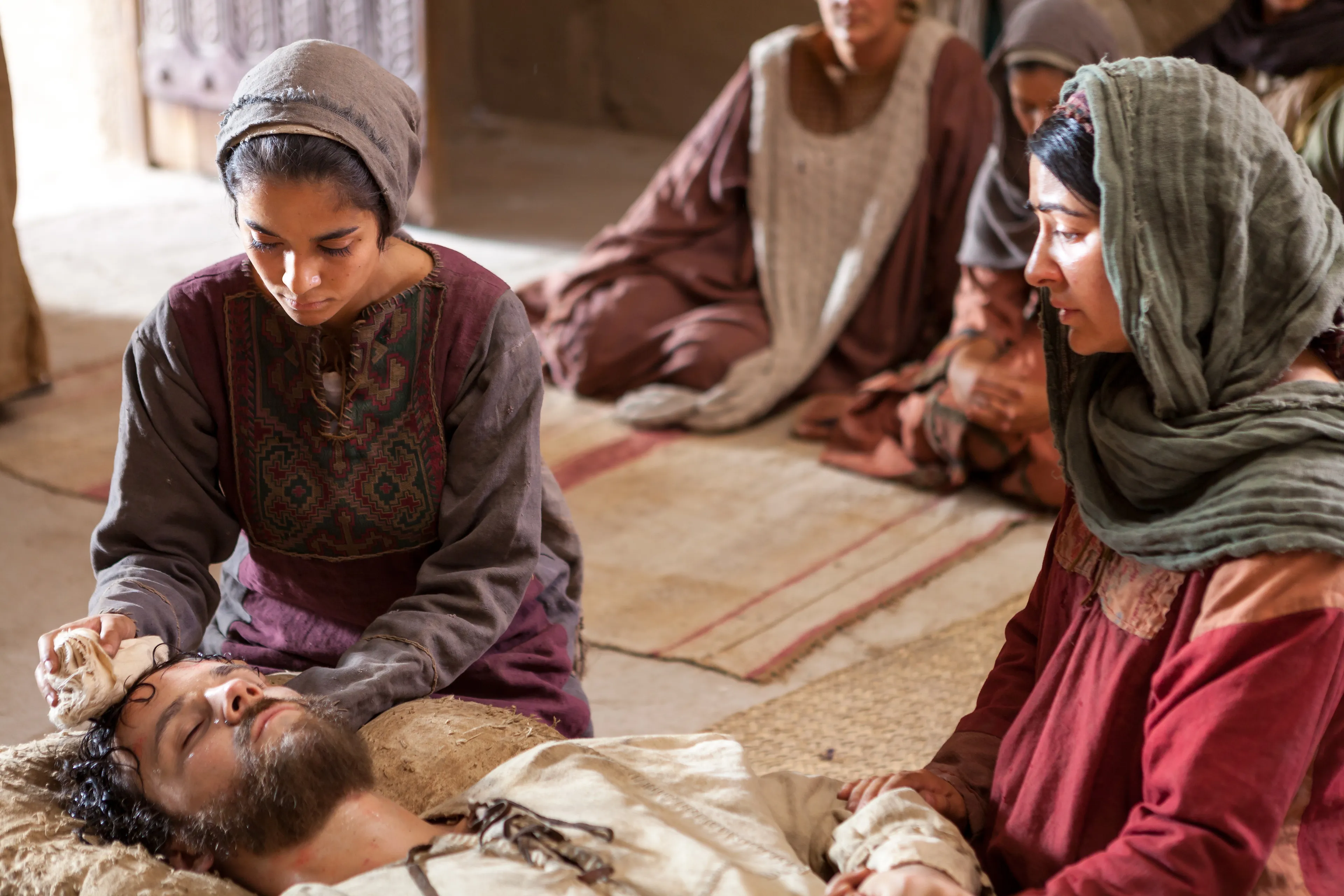 Mary and Martha tending to their brother Lazarus, who is ill.