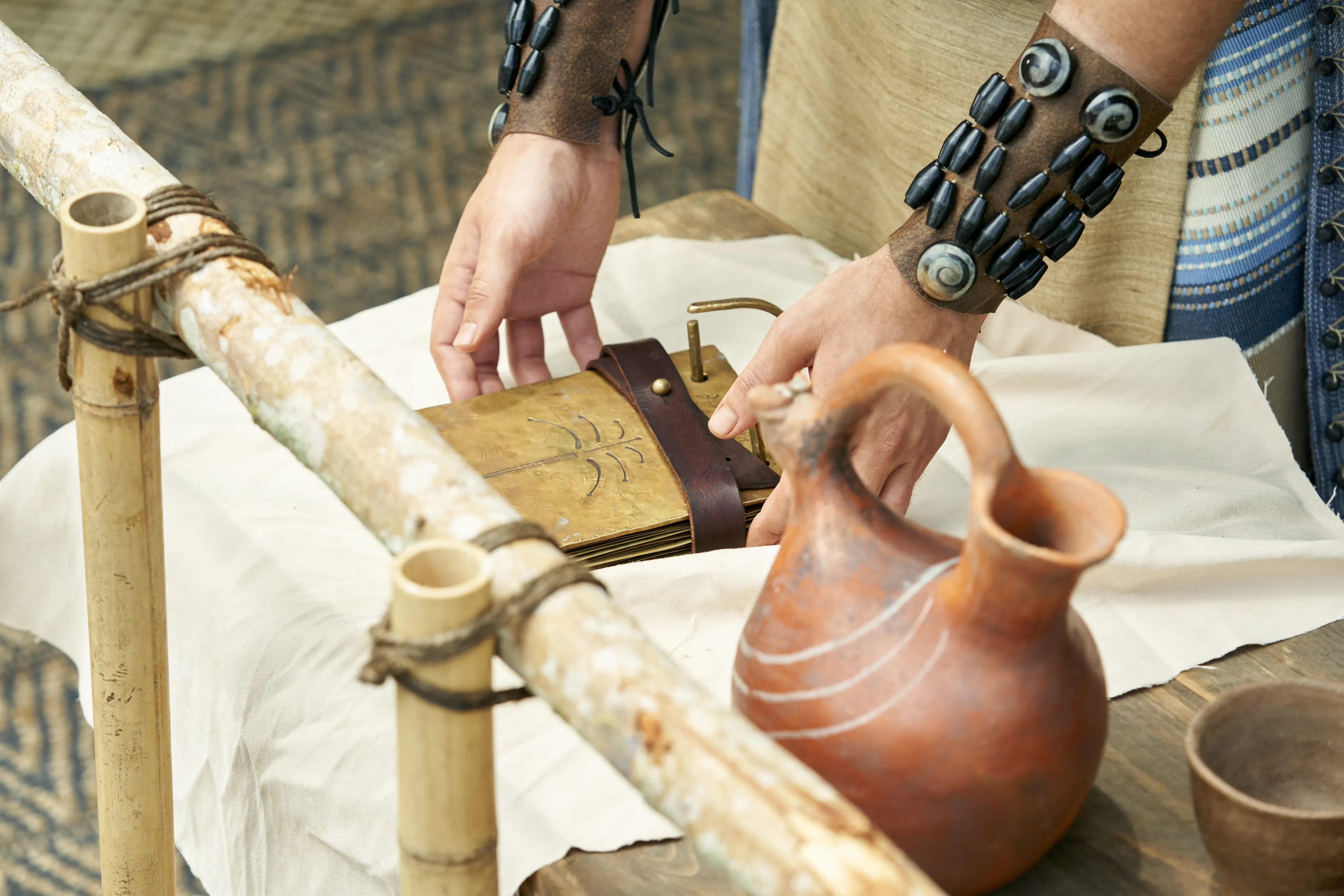 Mosiah reaches for the small plates as they rest on a table in the Land of Zarahemla.