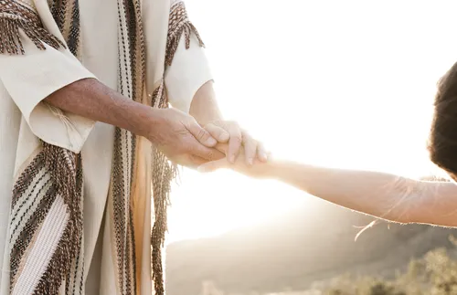 Jesus holding a person’s hand