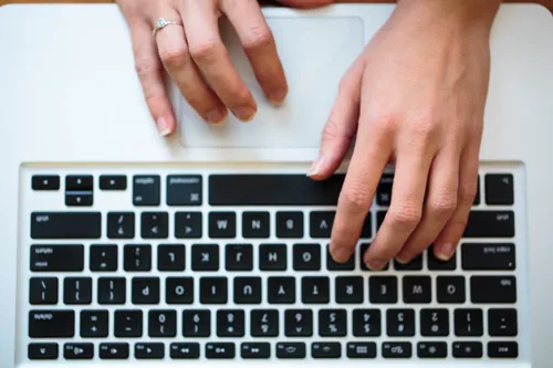 Hands on a computer keyboard