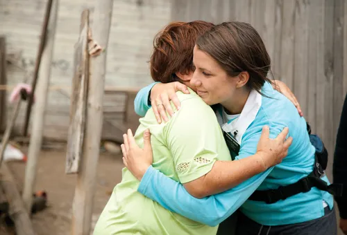 women embracing during emergency earthquake response efforts