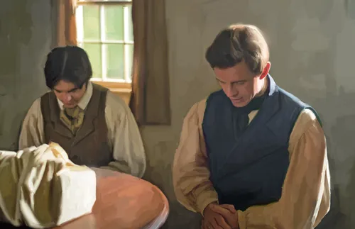 Joseph Smith and Oliver Cowdery bow their heads and pray before translating the Gold Plates.