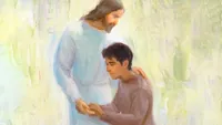A Hispanic man gives the Savior, Jesus Christ, a hug. Christ is wearing a white robe.