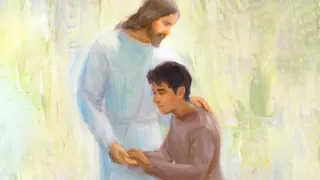 A Hispanic man gives the Savior, Jesus Christ, a hug. Christ is wearing a white robe.