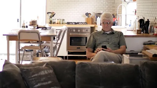 man sitting in kitchen