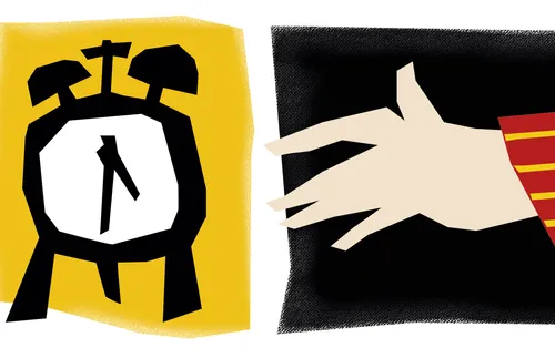 hand reaching for alarm clock