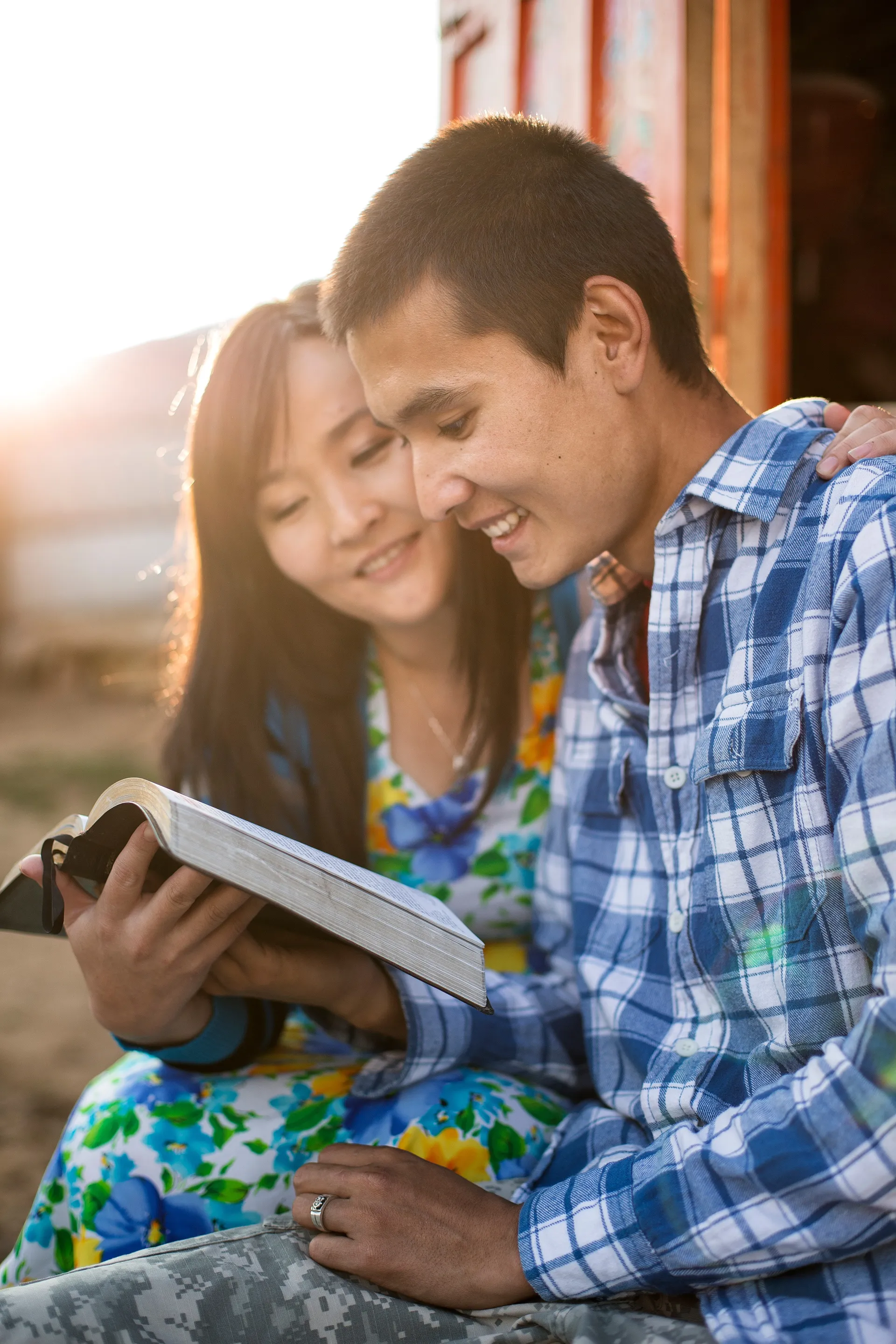 A young couple reading their scriptures together.