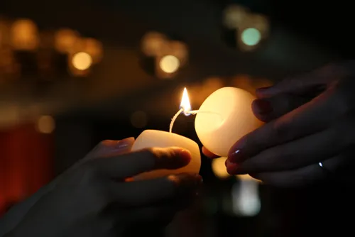 one candle sharing light with another