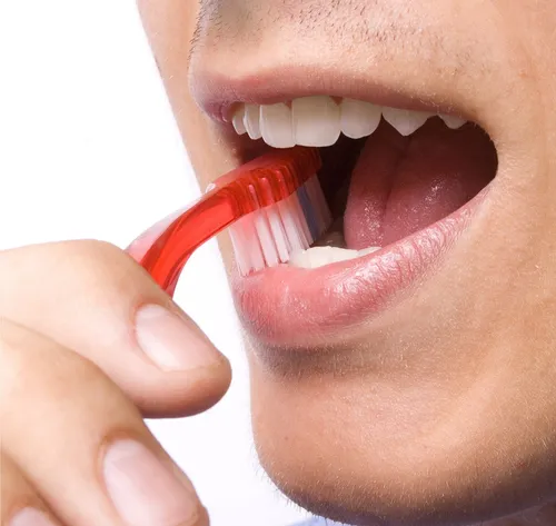 man brushing teeth close-up