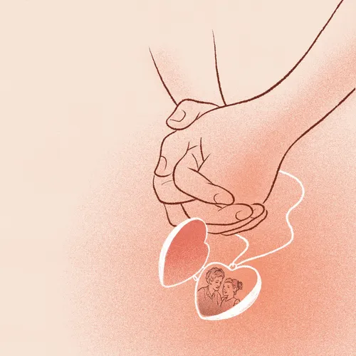 folded hands next to a locket