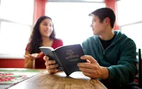 A couple study the Book of Mormon at their kitchen table learning how to get through hard times