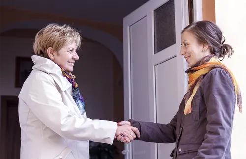 two women shaking hands