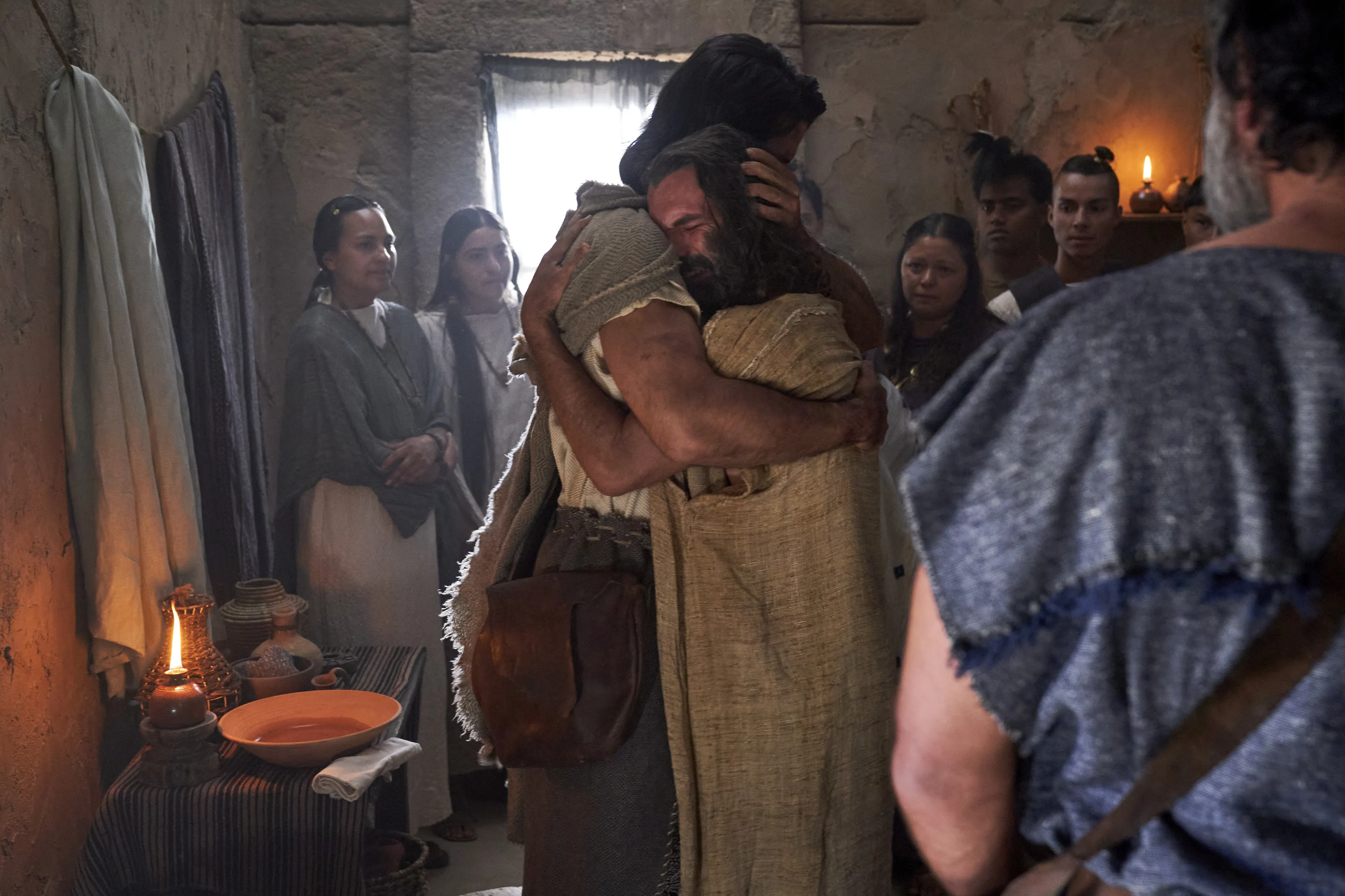 Zeezrom embraces Alma the Younger after being healed by him in the land of Shilom.