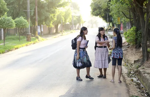 sister missionaries greeting woman