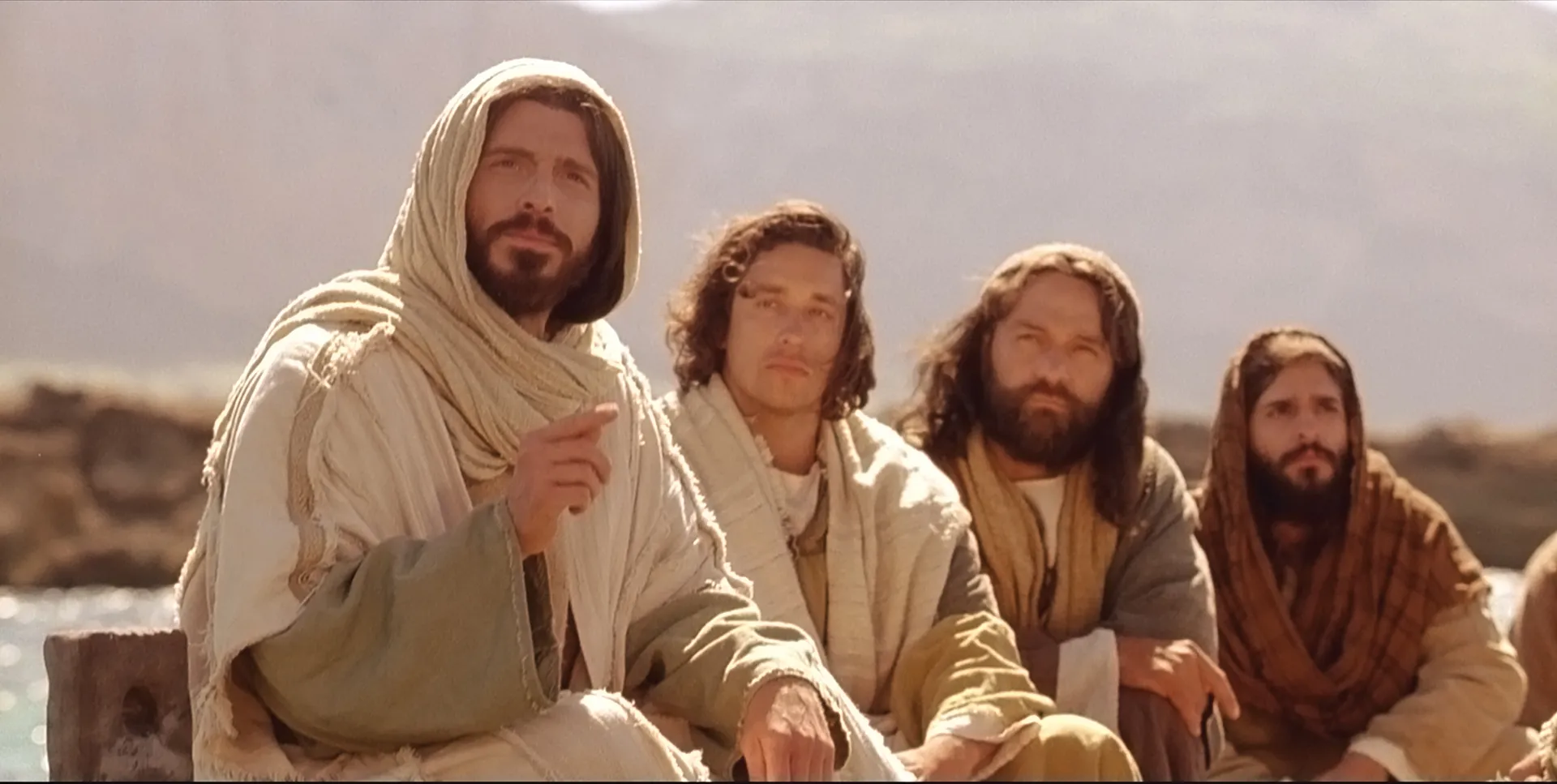 While on a ship, Jesus teaches parables to listeners on shore.