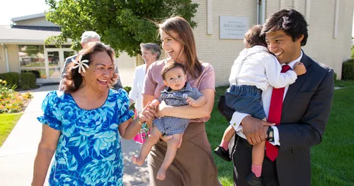 people walking in front of church
