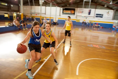 young women playing basketball