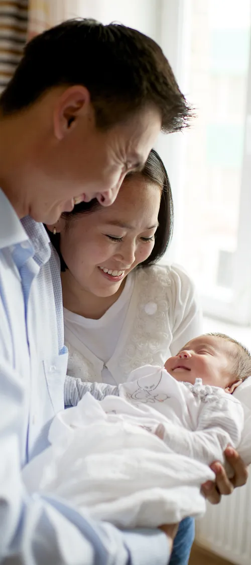 young couple holding infant