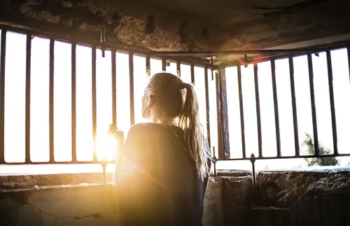 Young adult looking up into the light