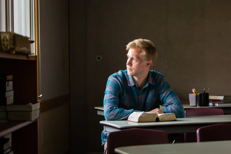 A man studies the scriptures at a desk and learns how to repent and receive forgiveness