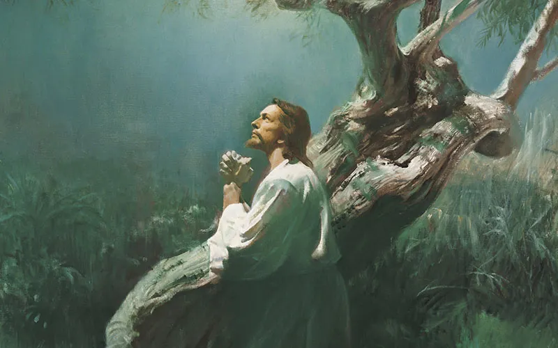 Jesus Christ kneels in prayer at the Garden of Gethsemane