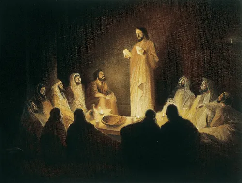 Jesus Christ depicted with the Apostles at the Last Supper. The Apostles are gathered around a table. Christ is standing before them and breaking bread as He institutes the sacrament.