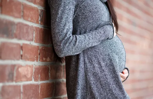 pregnant woman holding her belly