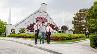 Missionaries teaching about the Temple to a new member outside the Seoul Korea Temple.