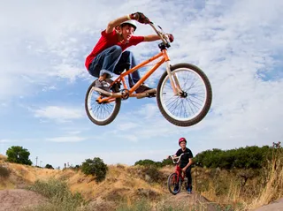 young man airborne on bicycle