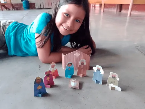 Gemma Rummler smiles as she shows off her paper nativity scene.