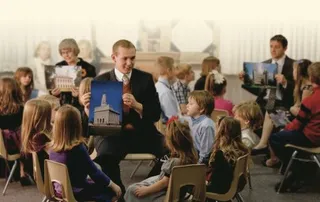 Primary teachers in groups in large room